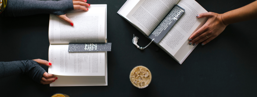5 Essential Books to Help Heal A Broken Relationship - Hands-of-two-women-turning-the-pages-of-separate-books on a table - Sandra Harewood