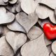 A Single Red Love Heart on Pile of Plain Wooden Hearts – What Does Love Mean - Sandra Harewood Counselling