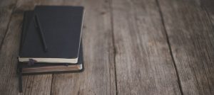 A notebook and pen on a wooden table - Blog - Sandra Harewood Counselling