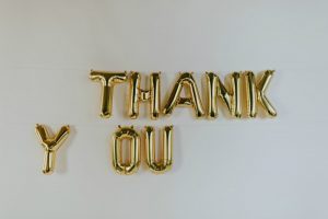 Gold "THANK YOU" balloon letters hanging on the wall