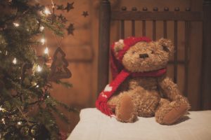 A Holiday Teddy Bear on A Stool - How To Survive Christmas And Reduce Your Christmas Anxiety - Christmas isn't a happy time for everyone. You might feel stamped if you feel a little low without quite understanding why. This post will give you some tips on how to feel less anxious and take care of yourself.