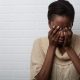 Black Woman Holding Her Head In Her Hands -What A Blue Fish Tells You About Your Anxiety - Sandra Harewood Counselling