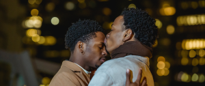 Two hung black men hugging closely - Sandra Harewood