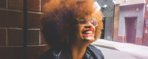 Black Woman With Afro Smiling - The Power of Owning Your Suppressed Anger: Reclaiming The Goddess