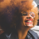 Black Woman With Afro Smiling - The Power of Owning Your Suppressed Anger: Reclaiming The Goddess