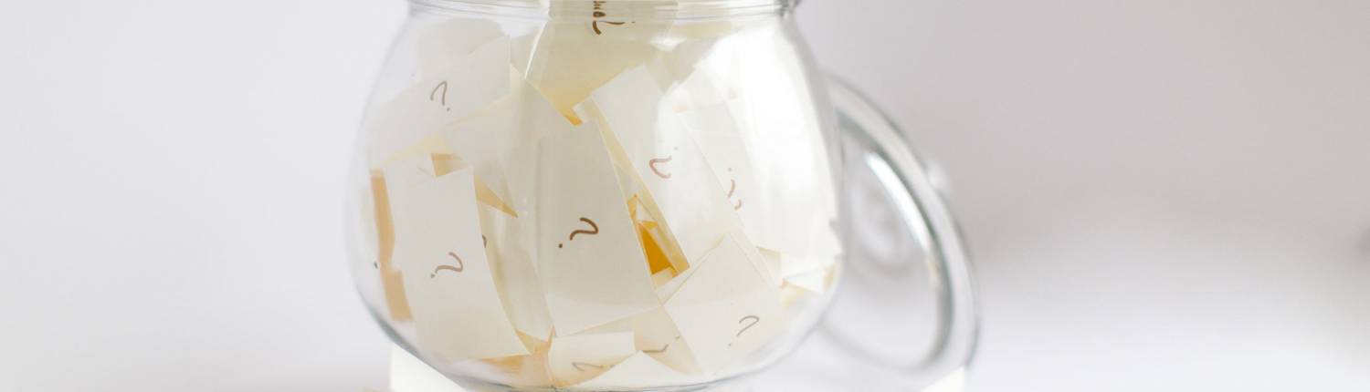 Pieces of paper with question marks in glass cup - Should I Stay or Should I Go Question Marks - Sandra Harewood