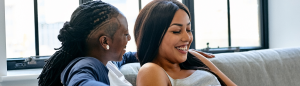 Black female same sex midlife couple talking in living room - Self-Awareness Strengthens Your Marriage - Sandra Harewood