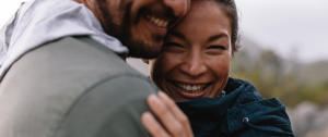 Mixed race couple smiling looking at each other and smiling - How to Handle Conflict Blog - Sandra Harewood