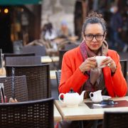 mature female model drinking tea in street cafe terrace in France, Europe Thoughtful mature woman drinking tea in cafe - Individual v Couples Therapy - Sandra Harewood