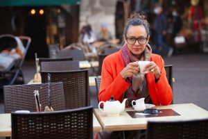 Thoughtful mature woman drinking tea in cafe - Individual v Couples Therapy - Sandra Harewood