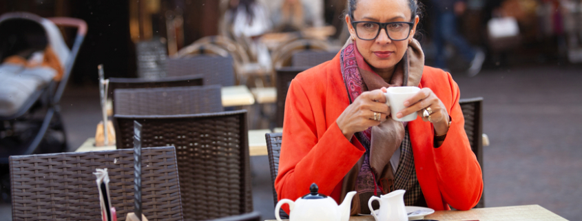 Thoughtful mature woman drinking tea in cafe - Individual v Couples Therapy - Sandra Harewood