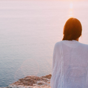 Unlocking the Benefits of Emotional Awareness in Relationships 2 Woman sitting on a cliff edge looking out on the ocean - Unlocking the Benefits of Emotional Awareness in Relationships - Sandra Harewood