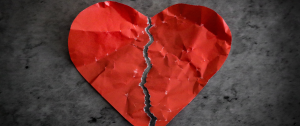 Red paper heart torn in half on dark background - How to recover and rebuild your relationship after an affair - Sandra Harewood