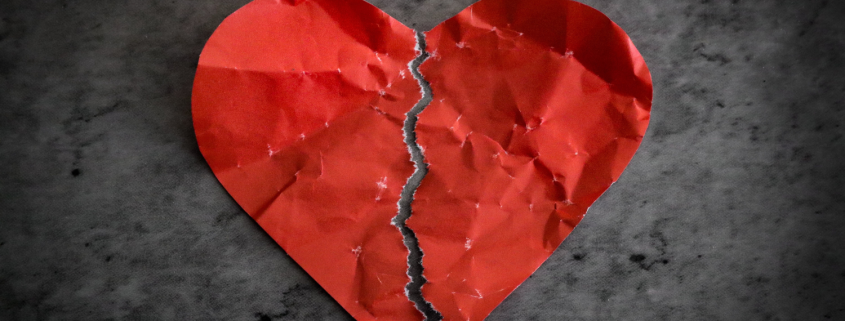 Red paper heart torn in half on dark background - How to recover and rebuild your relationship after an affair - Sandra Harewood