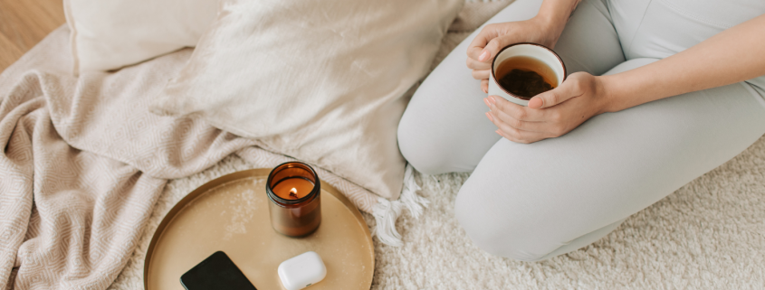 Woman on her knees holding a hot drink in a cup - 3 Steps to Finding Clarity While Stuck in Relationship Limbo