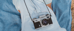 Woman lying down with old fashion camera resting on her tummy - The Hidden Signs Your Relationship Is in Trouble—and What to Do Next - Sandra Harewood