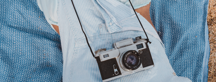 Woman lying down with old fashion camera resting on her tummy - The Hidden Signs Your Relationship Is in Trouble—and What to Do Next - Sandra Harewood