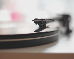 A close-up of a vinyl record gently spinning on a turntable, symbolising the harmony and rhythm between different parts of the self.