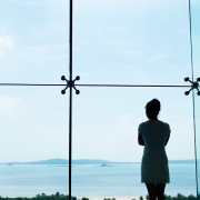 At a Relationship Crossroads? Why This Moment Deserves Care, Not Crisis Woman looks of a window to the ocean - At a Relationship Crossroads? Why This Moment Deserves Care, Not Crisis