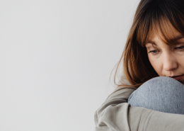 Bored But Still Together? Sad Woman Sat Hugging Here Knees - What Boredom in a Good Relationship Might Really Mean - Sandra Harewood