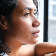 thoughtful black woman looking out of a window