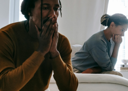 Unhappy couple sitting apart on a sofa - We Have Different Values: Should I Stay Or Go?