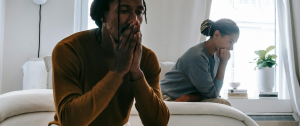 Unhappy couple sitting apart on a sofa - We Have Different Values: Should I Stay Or Go?