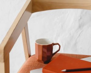 A journal beside a cup of tea, symbolising self-reflection and healthier alternatives to drinking