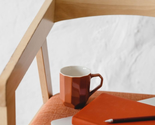 A journal beside a cup of tea, symbolising self-reflection and healthier alternatives to drinking