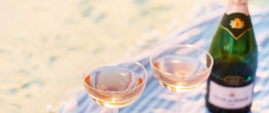 Two filled champagne glasses and a bottle of champagne symbolising social drinking and the early signs of problem drinking in midlife women.