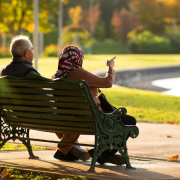Senior couple walking together through an autumn park, reflecting the quiet intimacy of long-term love.