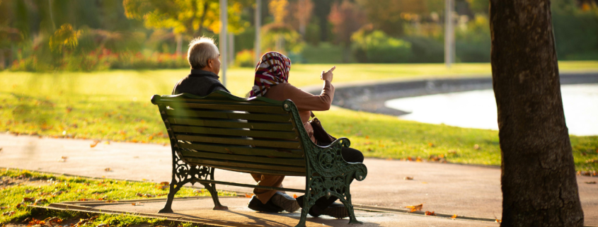 Senior couple walking together through an autumn park, reflecting the quiet intimacy of long-term love.