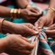 Women weaving a traditional textile together, symbolising creativity, connection and the gradual expression of the authentic self.